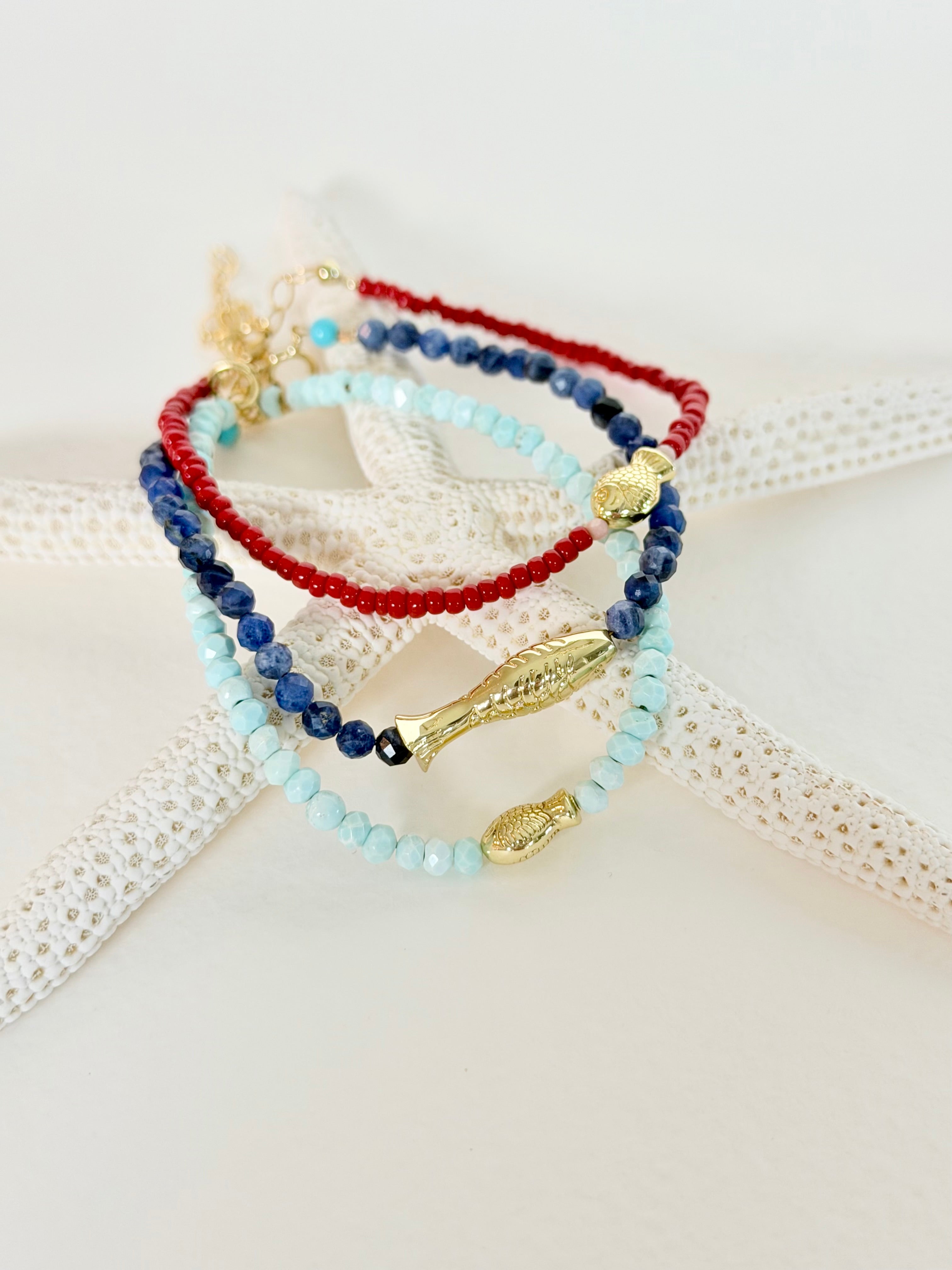 Sea to Shining Sea Collection featuring red, white, blue & turquoise bracelets on a starfish