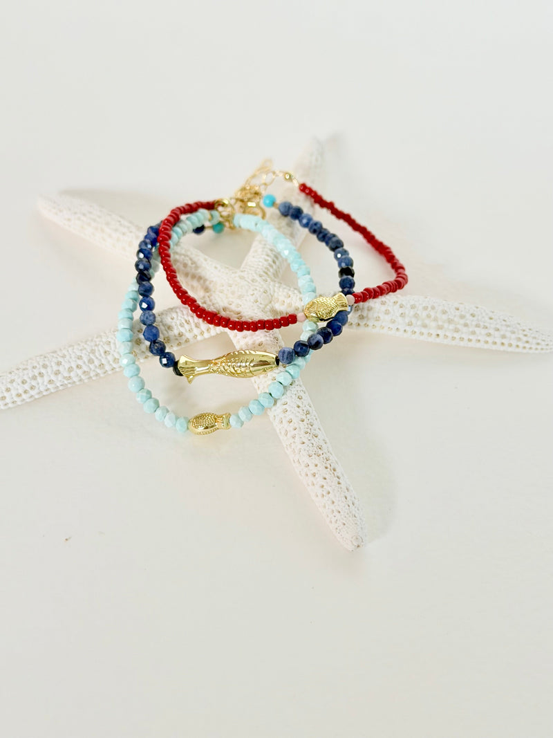 Sea to Shining Sea Collection featuring red, white, blue & turquoise bracelets on a starfish