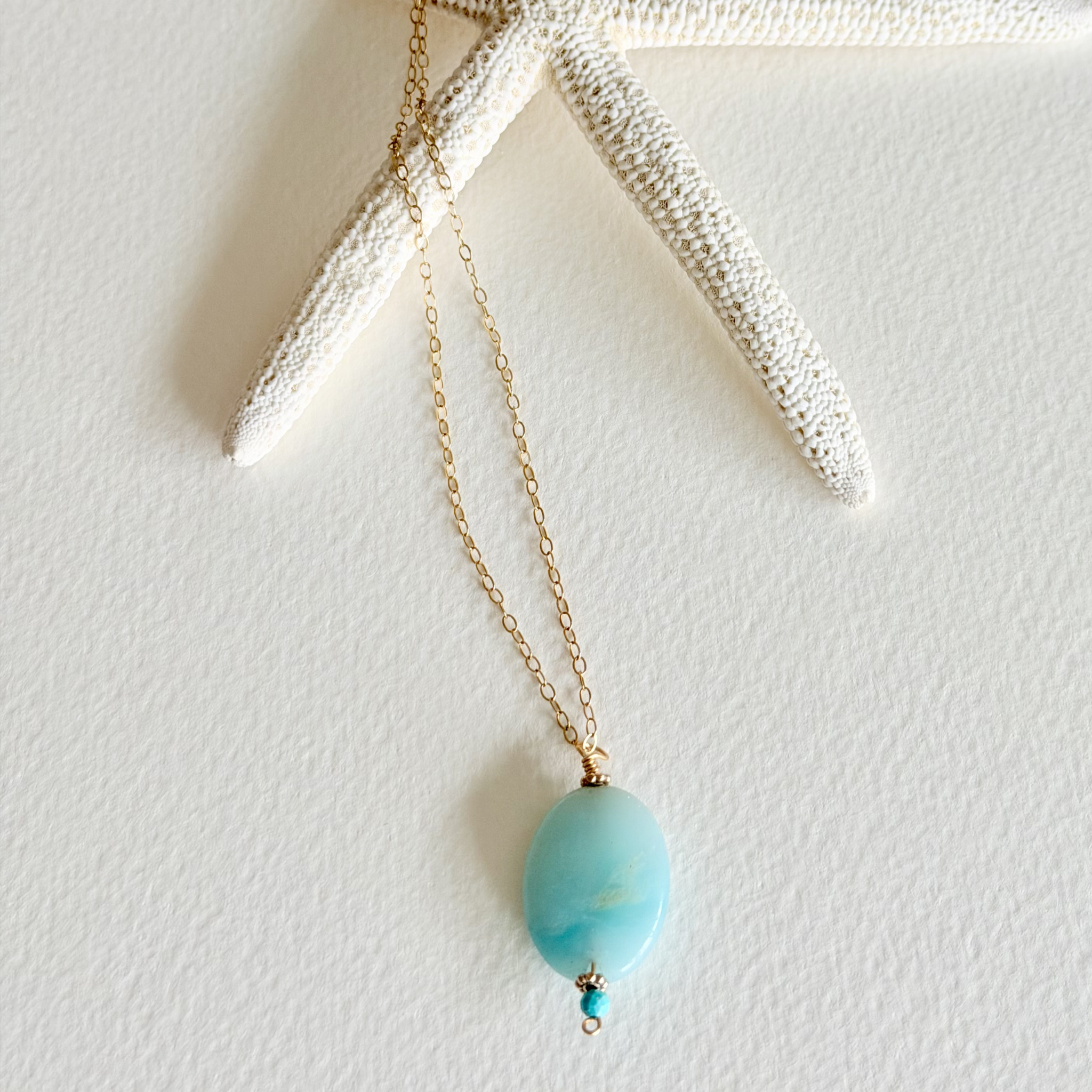 Necklace with a turquoise pendant on a white background