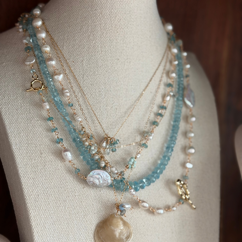 Necklace with pearls and gemstones on a mannequin bust