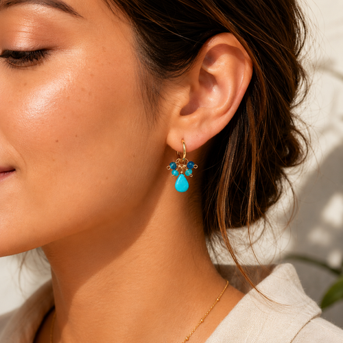 Close-up of a woman wearing a turquoise earring with a blurred background