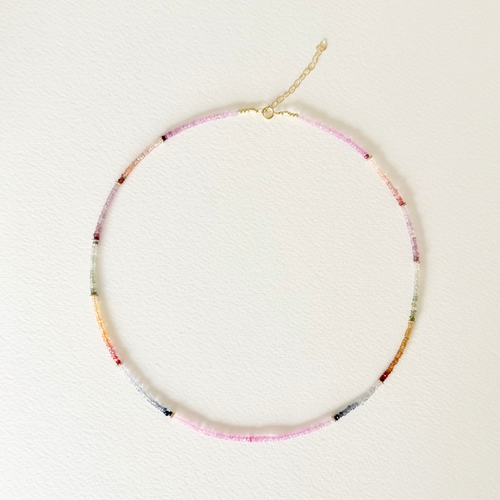multi colored sapphire beaded necklace on light background