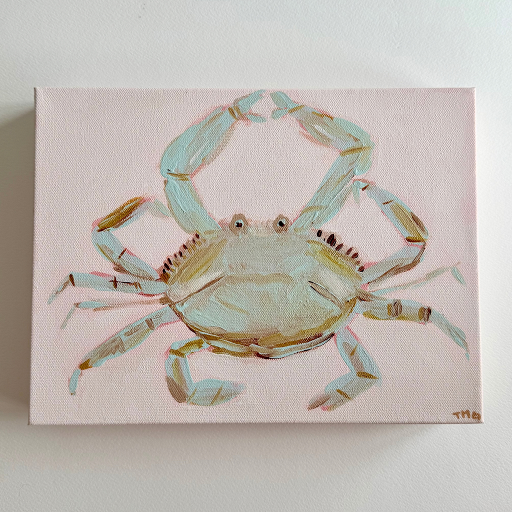 A rectangular acrylic canvas painting of a light blue-green crab on a pale pink background, mounted on a white wall.