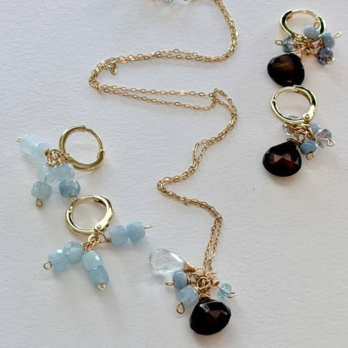 Dainty Necklace and huggie earrings with gold chains and gemstone beads on a light background