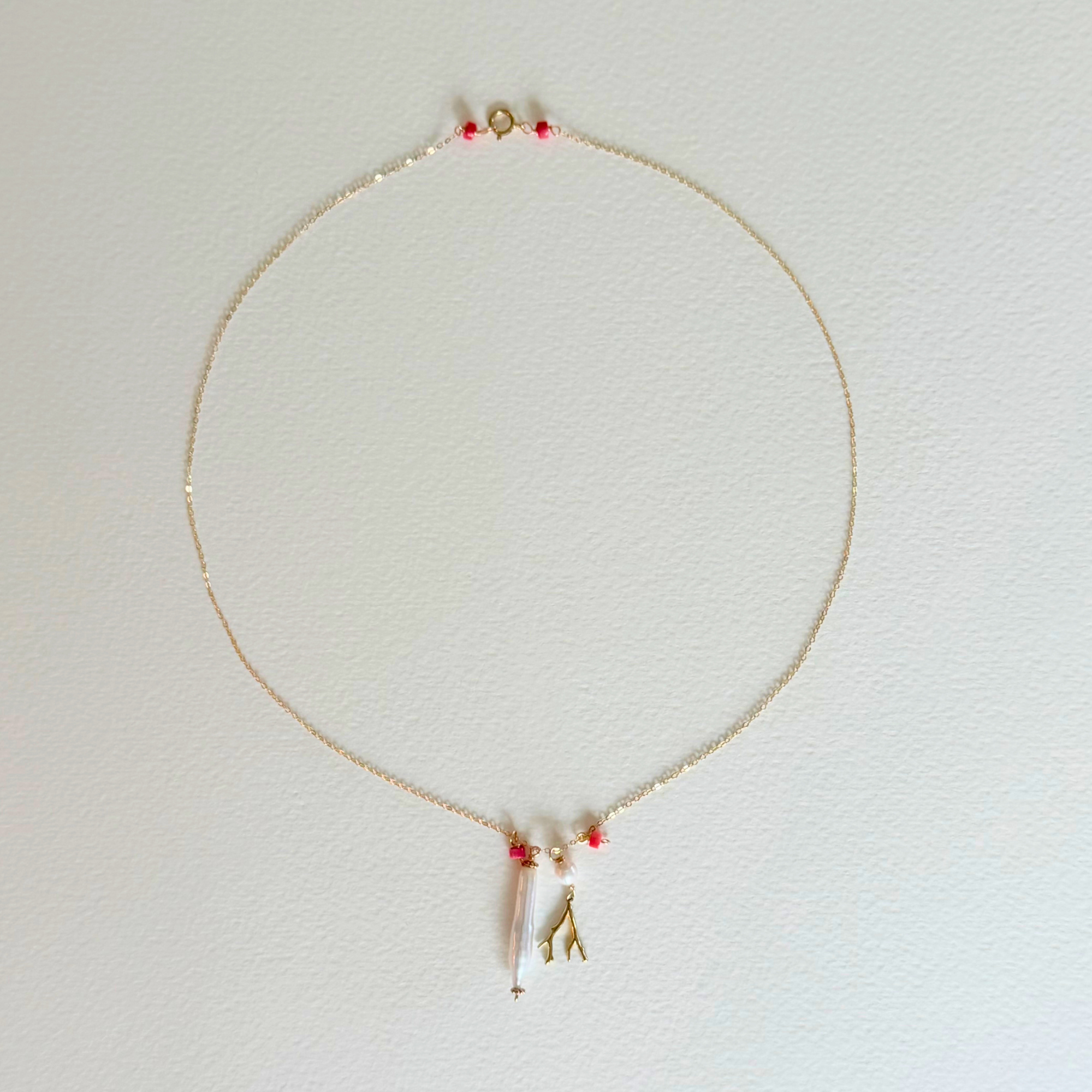 Necklace with small pendants on a light gray background