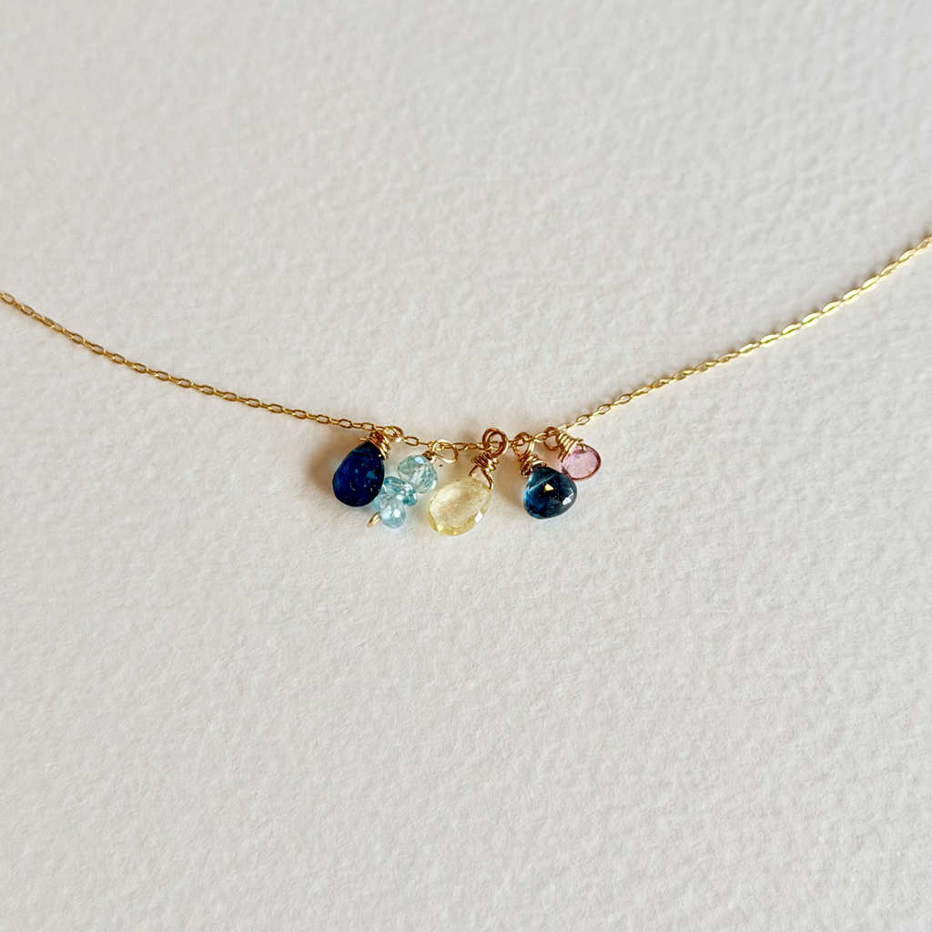 Necklace with colorful gemstones on a light gray background