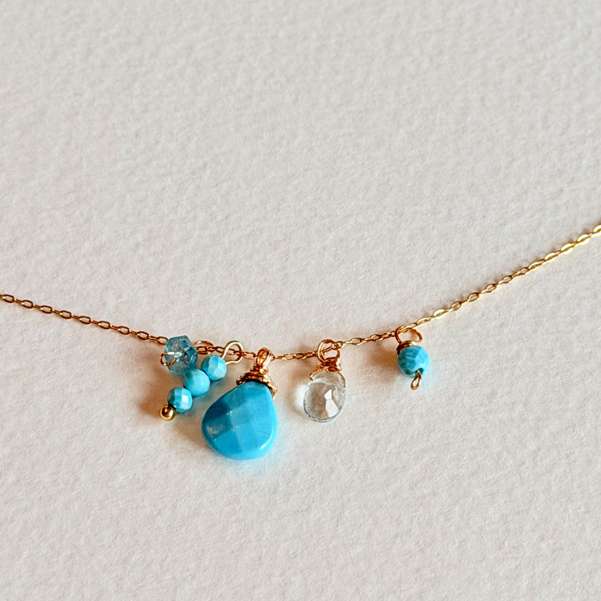 Necklace with turquoise beads on a light gray background