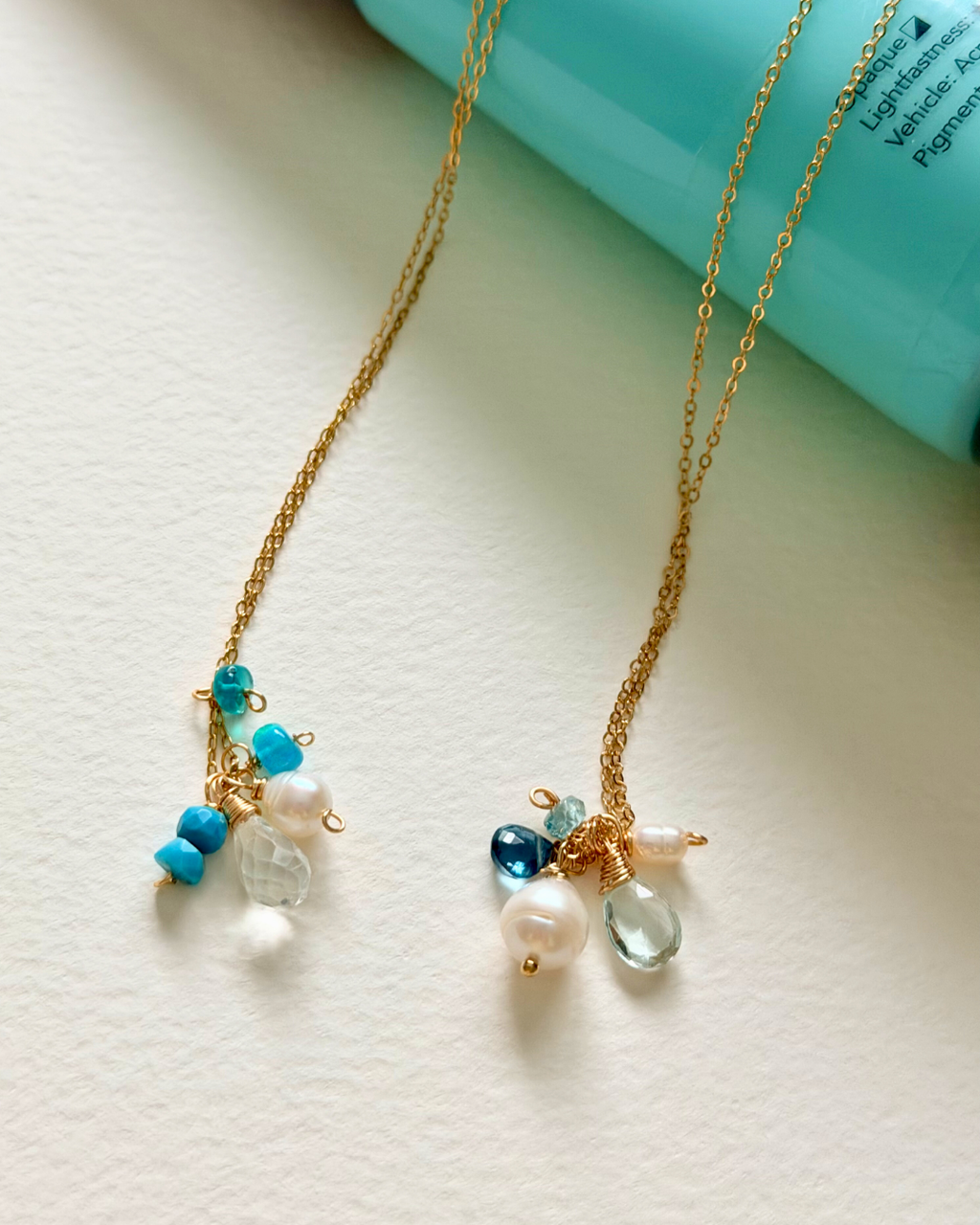 Necklace with blue and clear bead charms on a light background