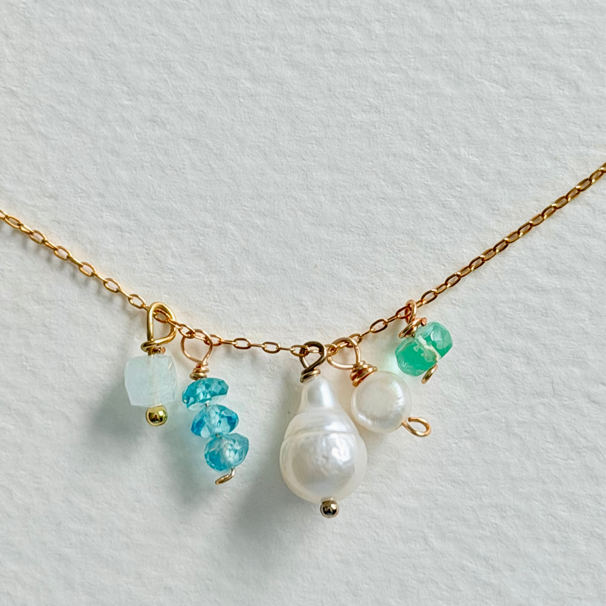 Necklace with pearls and turquoise beads on a light background