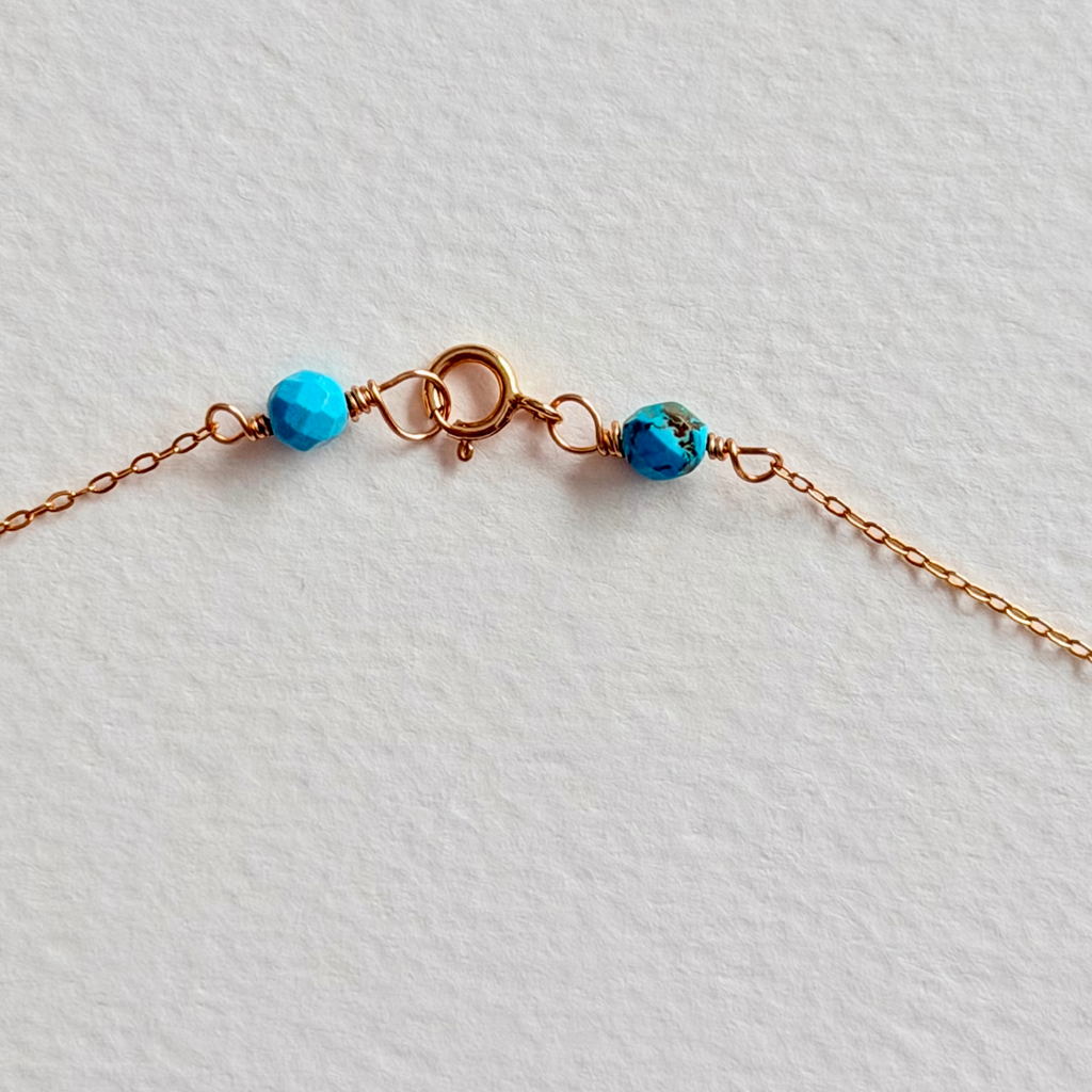 Necklace with blue beads on a light gray background