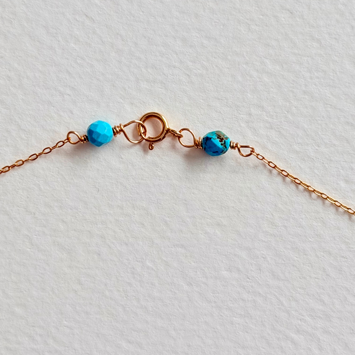 Necklace with blue beads on a light gray background