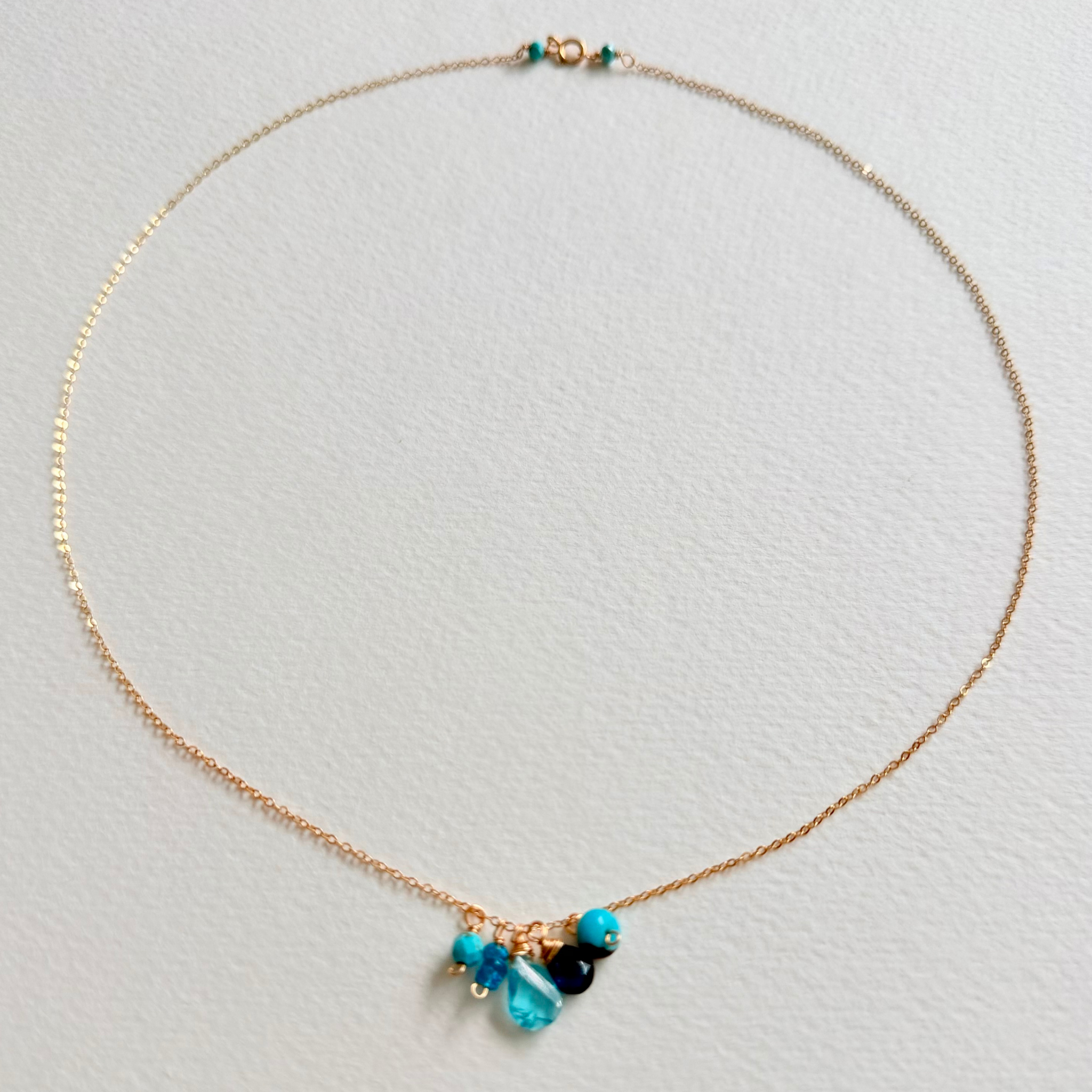 Necklace with blue beads on a light gray background