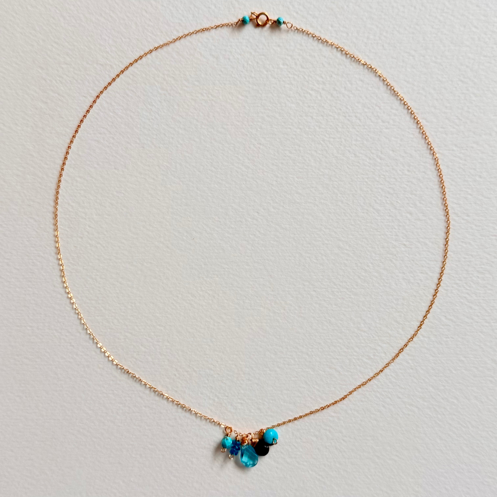 Necklace with blue beads on a light gray background