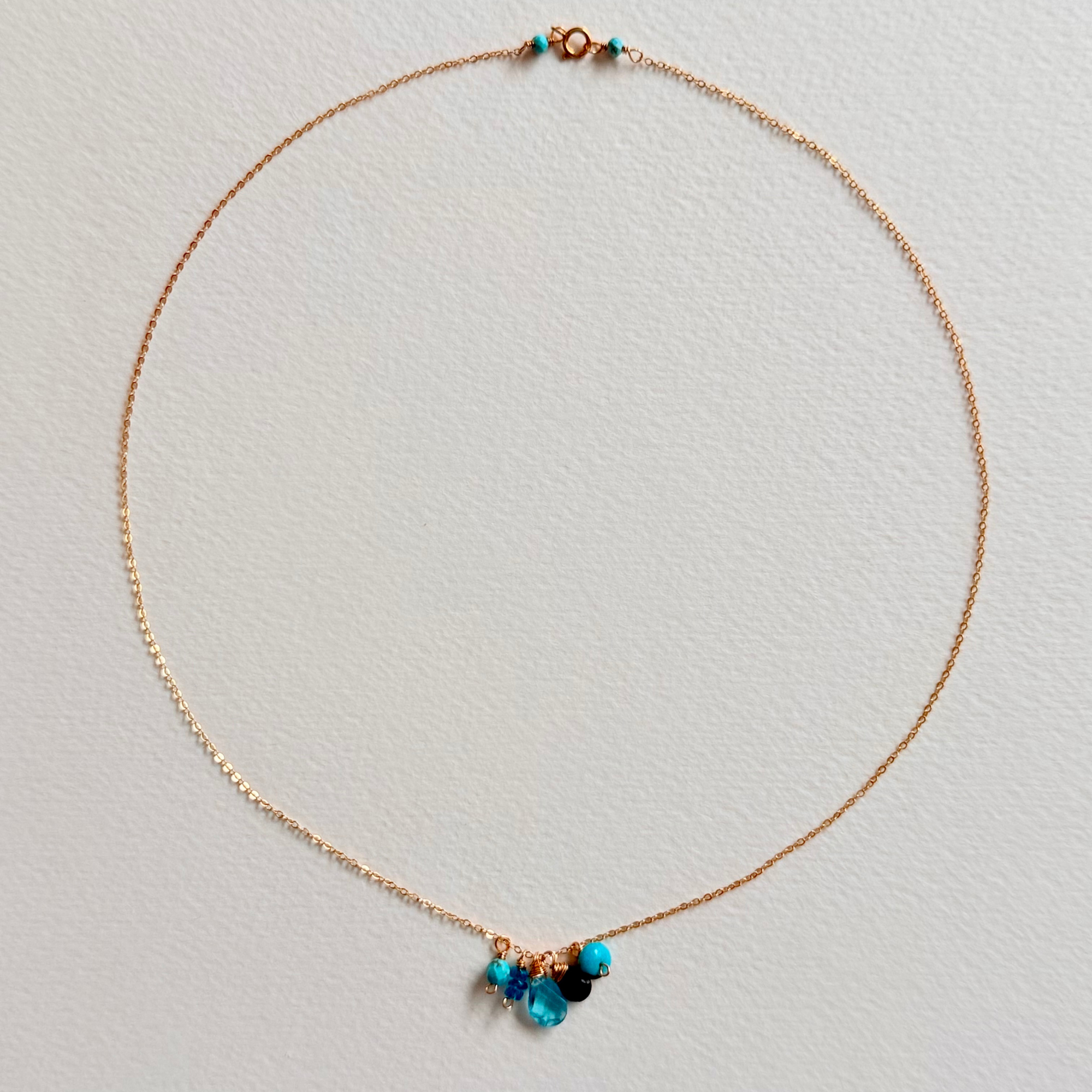Necklace with blue beads on a light gray background