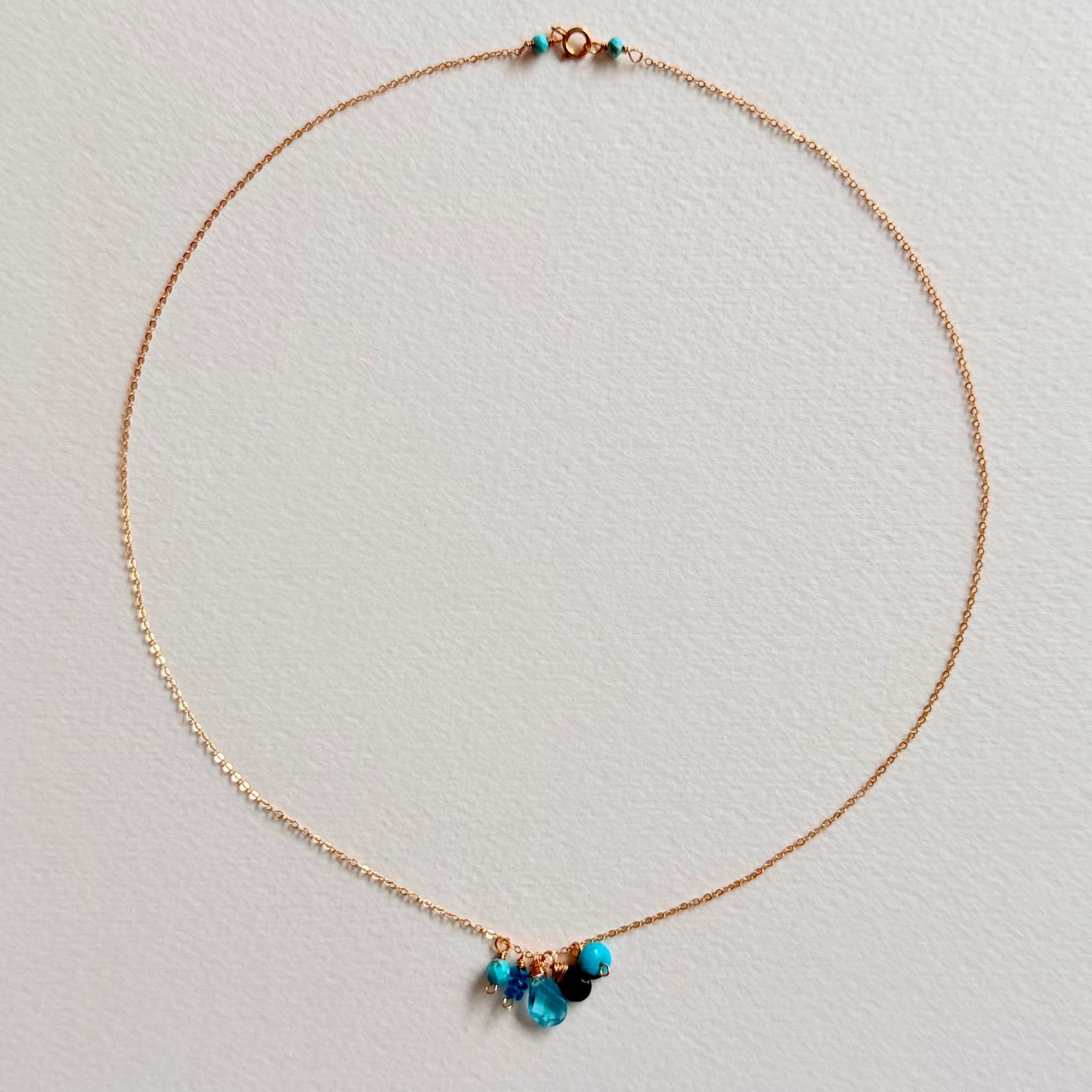 Necklace with blue beads on a light gray background
