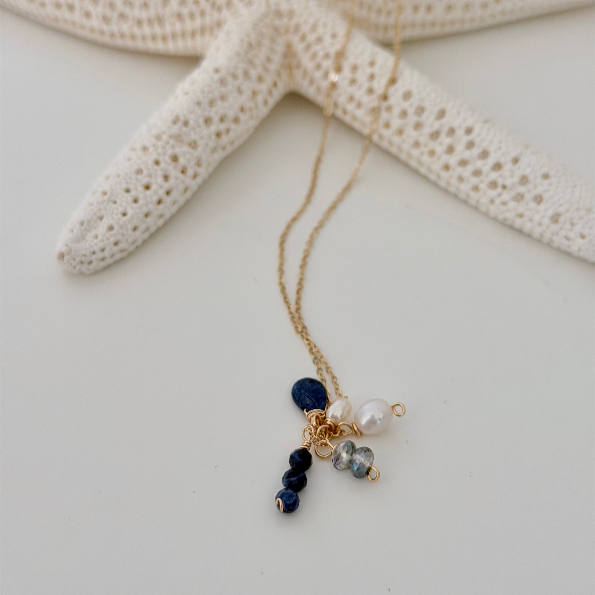 Necklace with blue and white beads on a starfish background