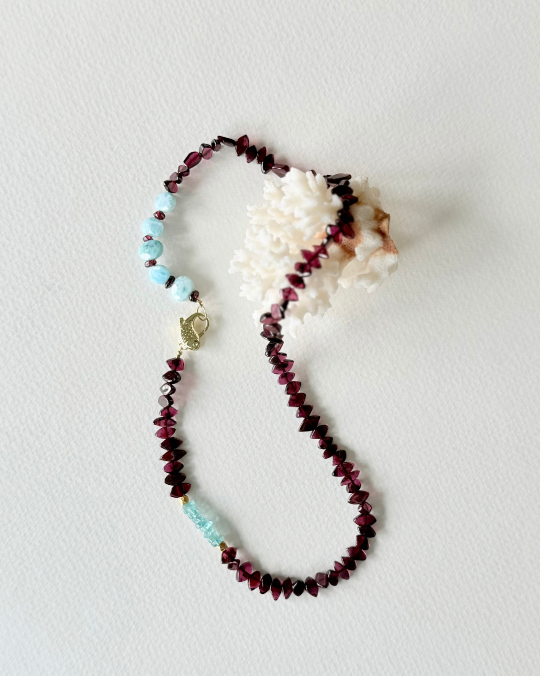 Deep Water garnet, larimar and aquamarine necklace styled with white coral