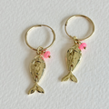 Gold fish-shaped earrings with pink beads on a white background