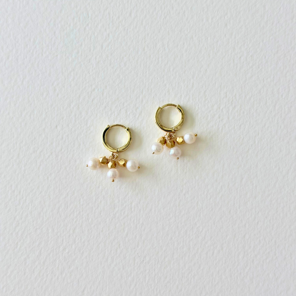 gold hoop huggie earrings with pearl charms