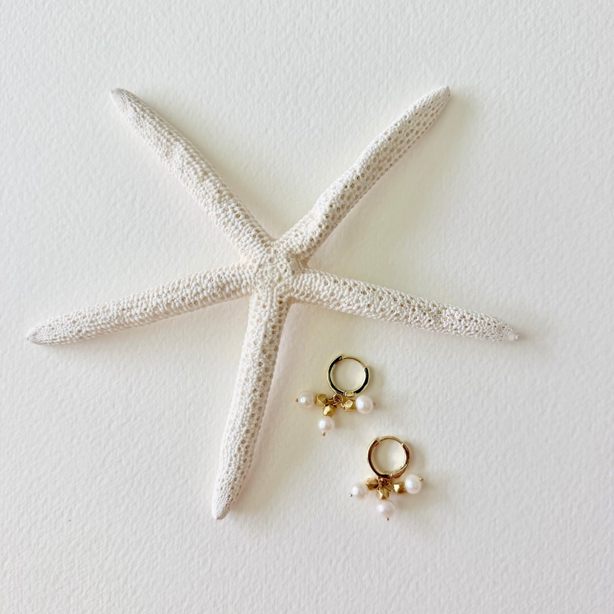 gold hoop huggie earrings with pearl charms