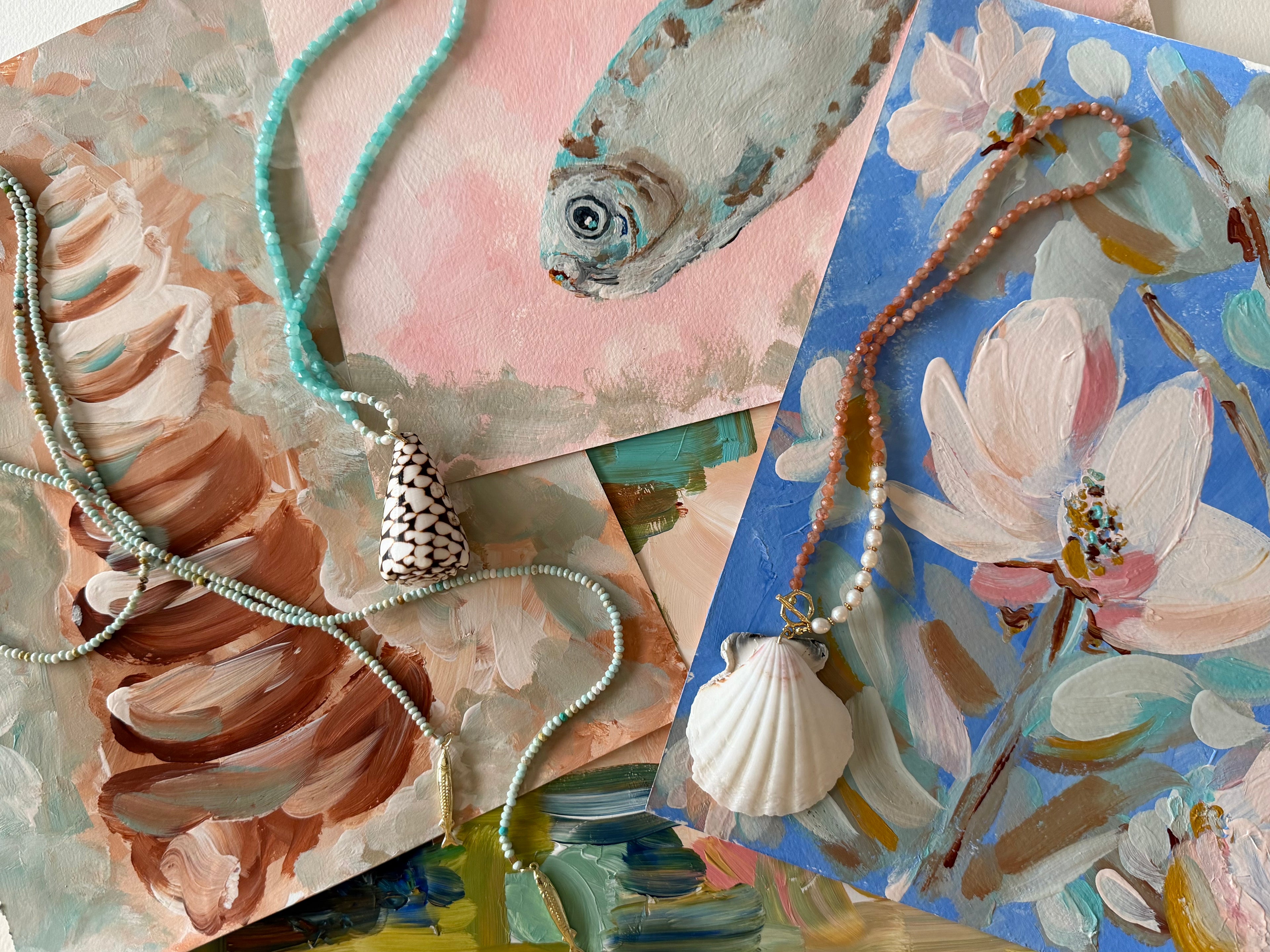 Jewelry with seashell and fish design on a floral and abstract art background