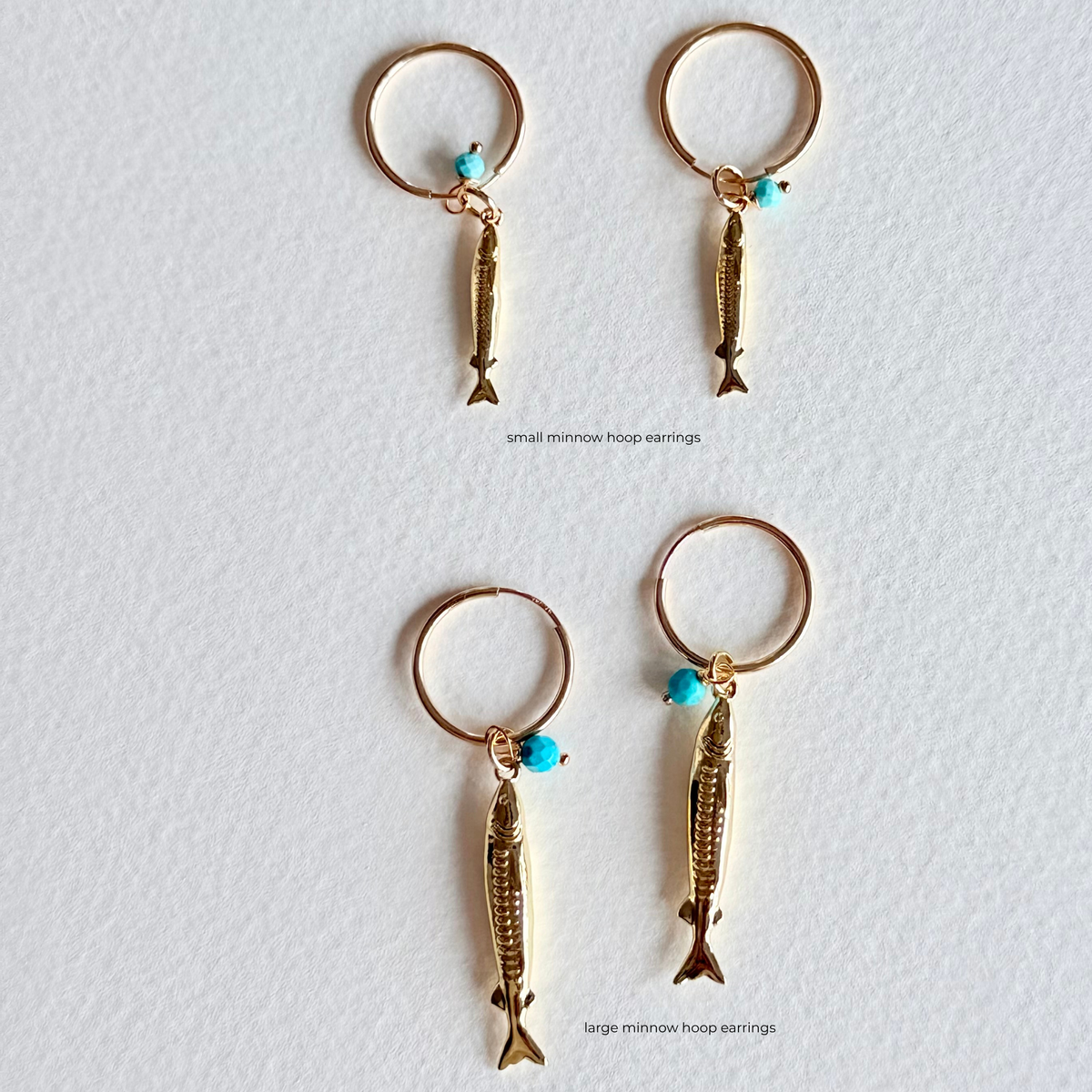 Small and large minnow hoop earrings on a white background
