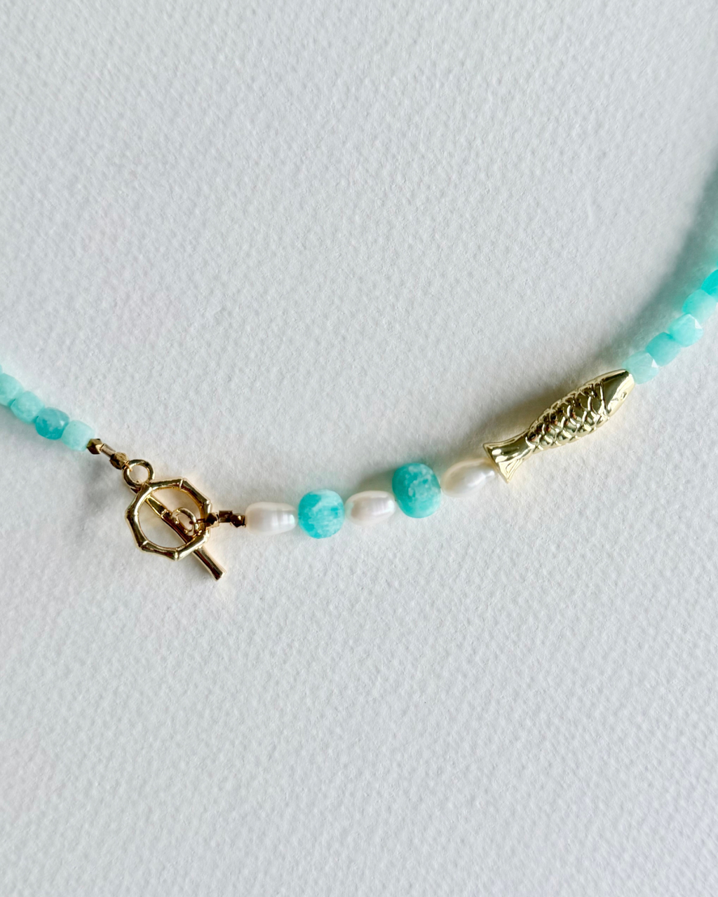 Little Catch Amazonite and pearl necklace close-up of 14k gold-filled toggle clasp and fish detail