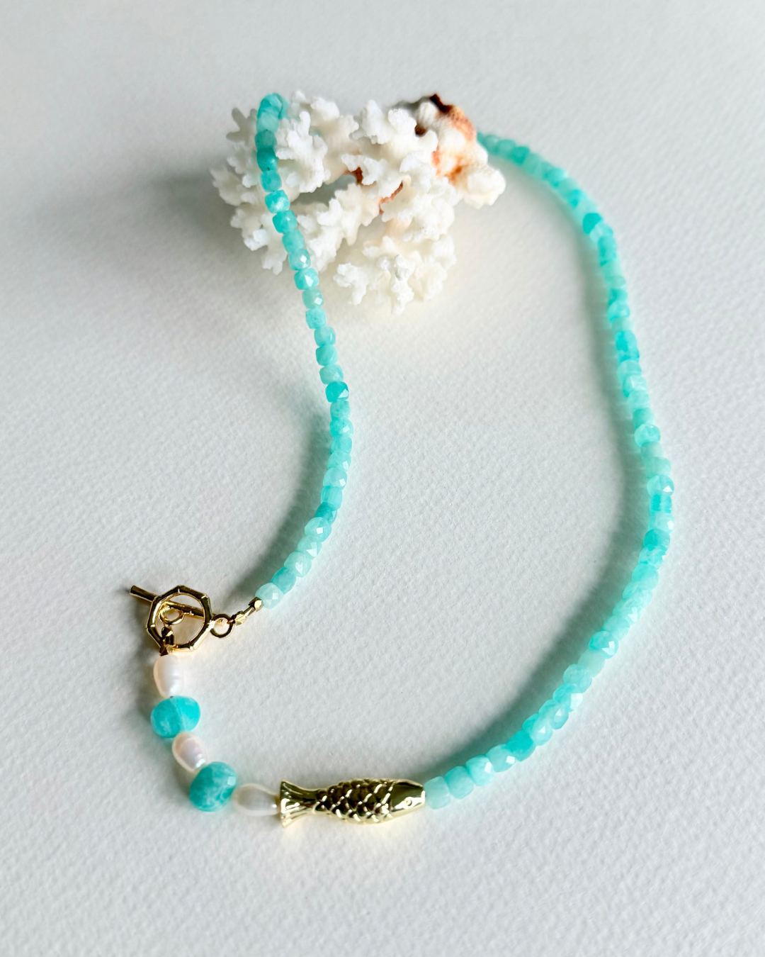 Little Catch Amazonite and pearl fish necklace styled with white coral
