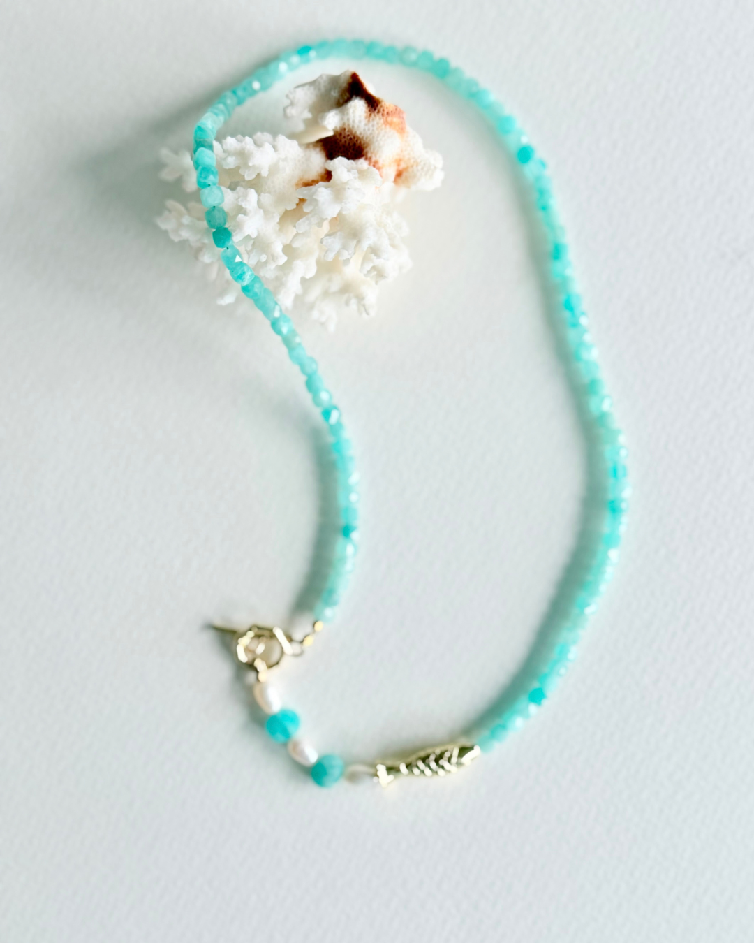 Little Catch Amazonite and pearl necklace with gold fish focal styled with coral
