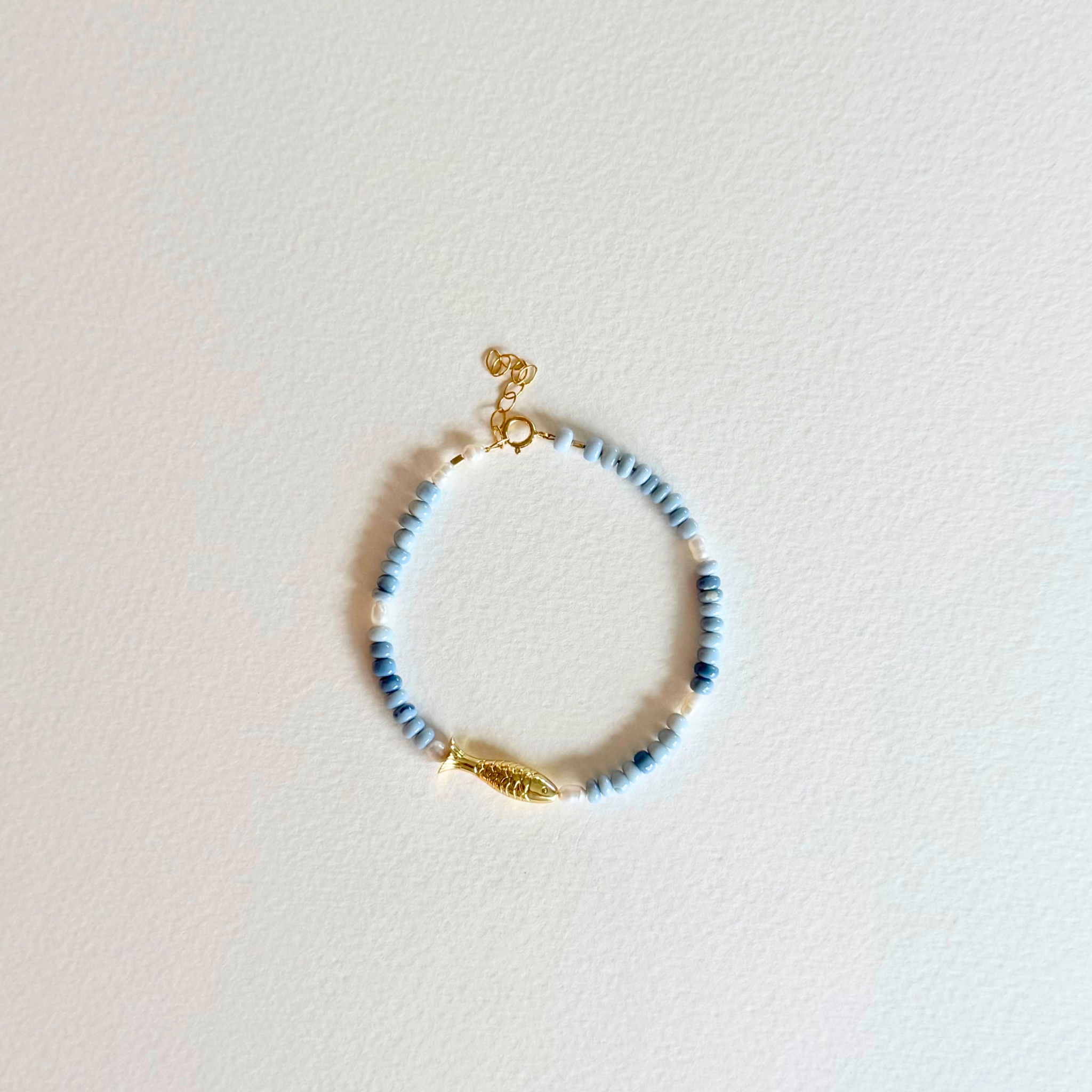 Beaded bracelet with gold accents on a light background