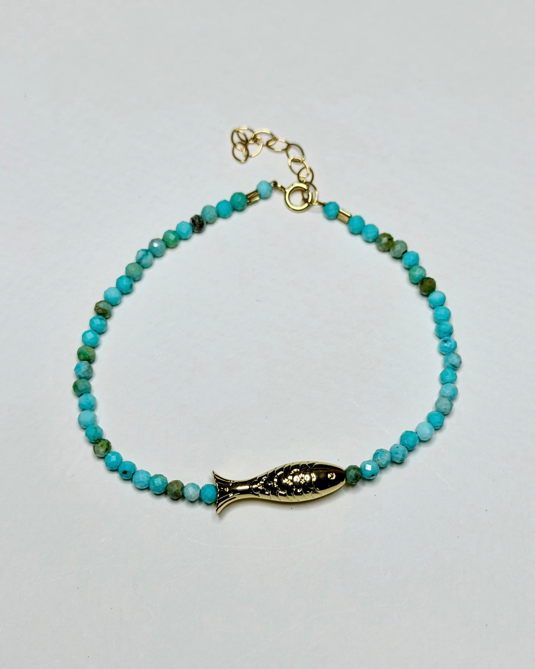 - Coastal turquoise fish bracelet with petite faceted gemstones and gold fish accent by Marie & Oakley