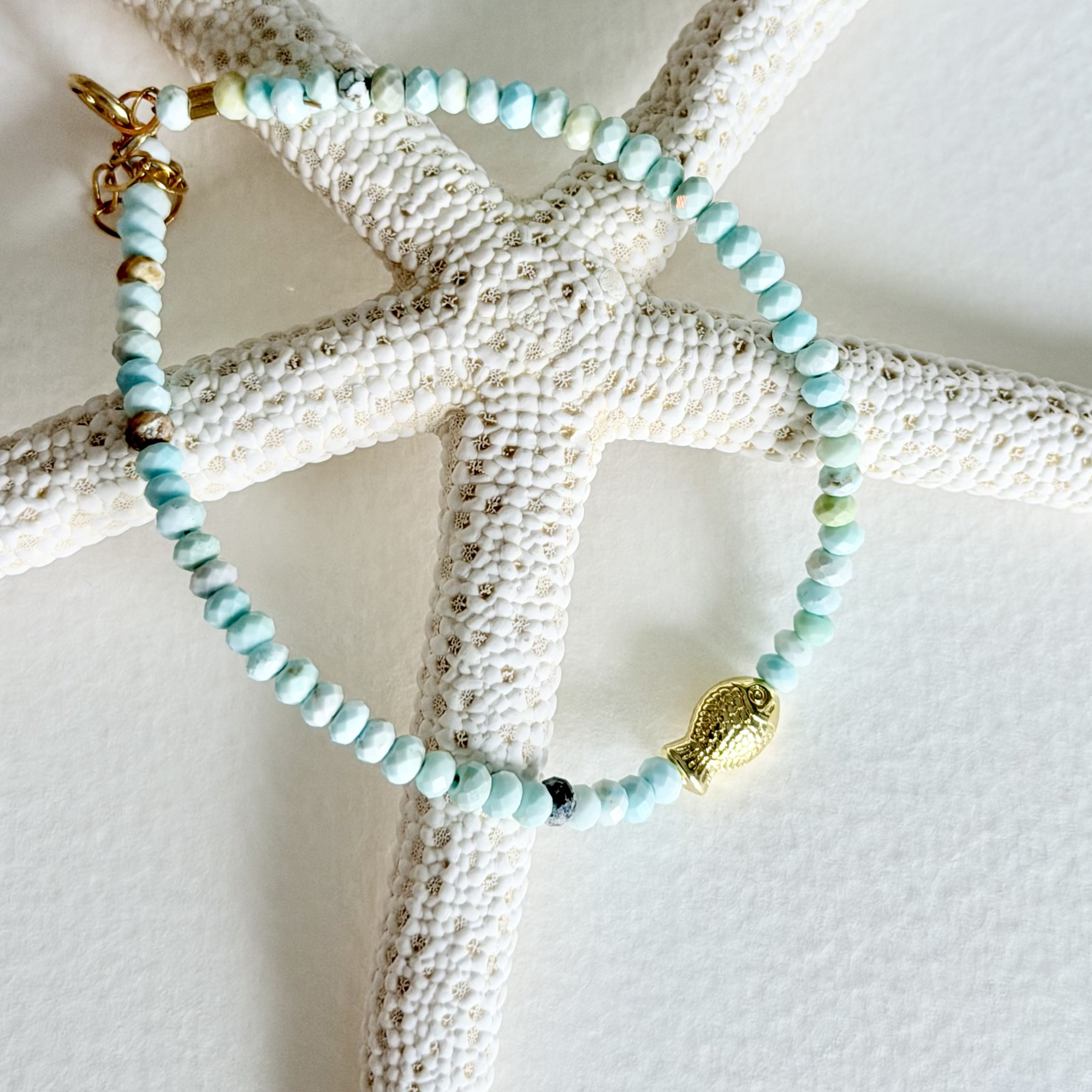 Beaded bracelet with gold accents on a starfish