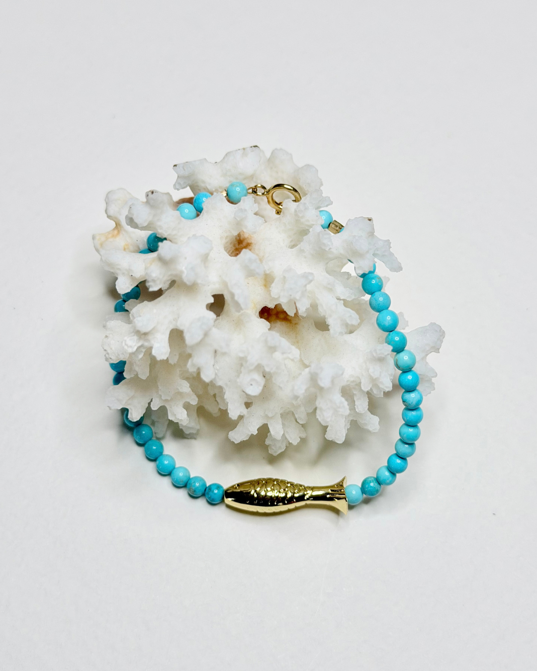 Bright blue turquoise fish bracelet with gold fish centerpiece and 14k gold-filled details by Marie & Oakley