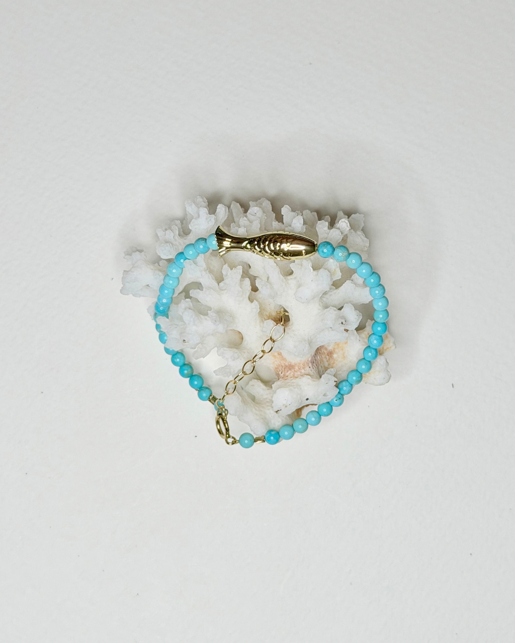 Bright blue turquoise fish bracelet with gold fish centerpiece and 14k gold-filled details by Marie & Oakley