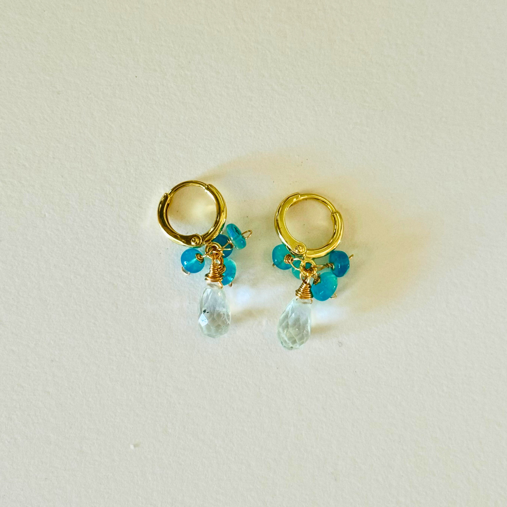 14k Gold filled huggie earrings with ethiopian blue opal and beryl clear bead drops on a light background