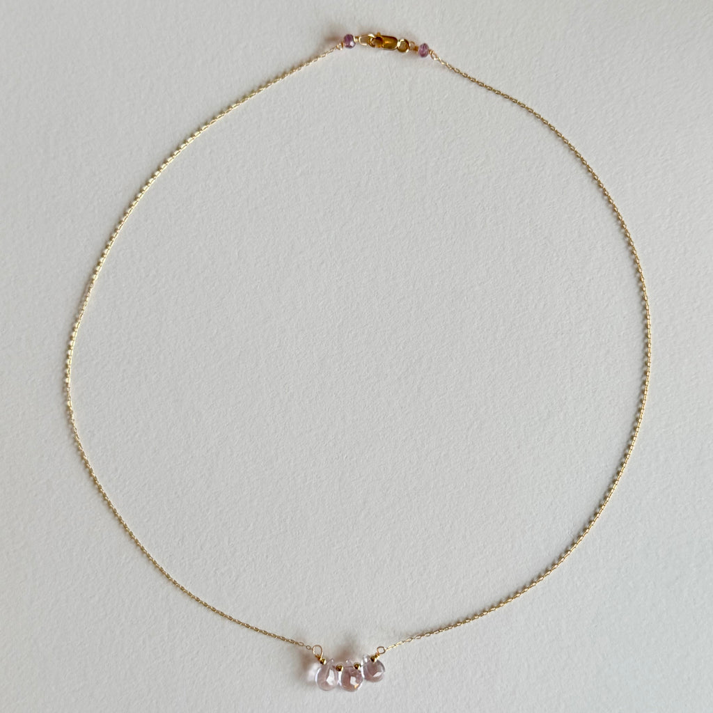 Delicate necklace with small beads on a light gray background