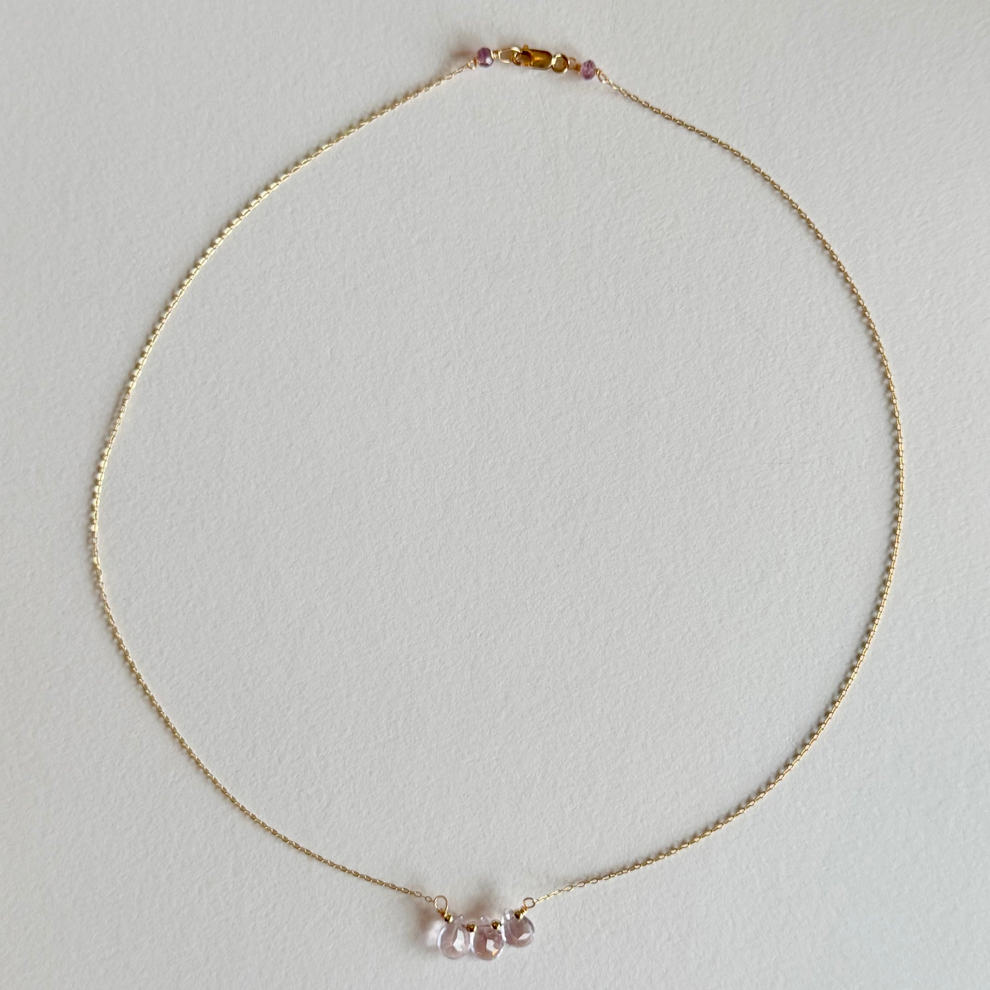 Delicate necklace with small beads on a light gray background