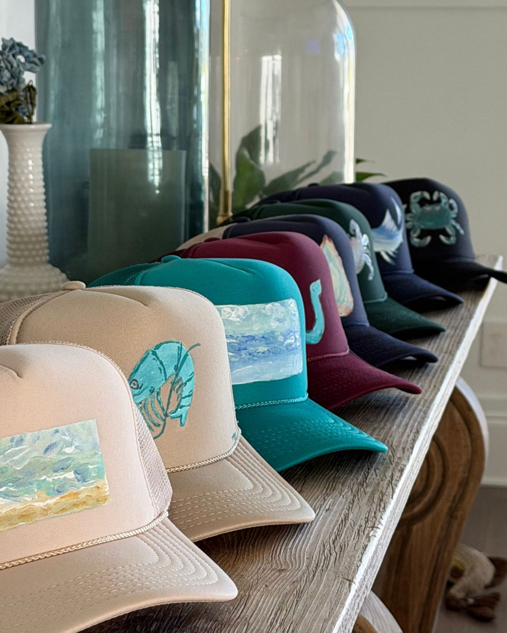 Collection of hand painted trucker hats by Tracy Marie