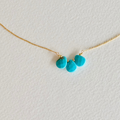 Necklace with turquoise pendants on a light background
