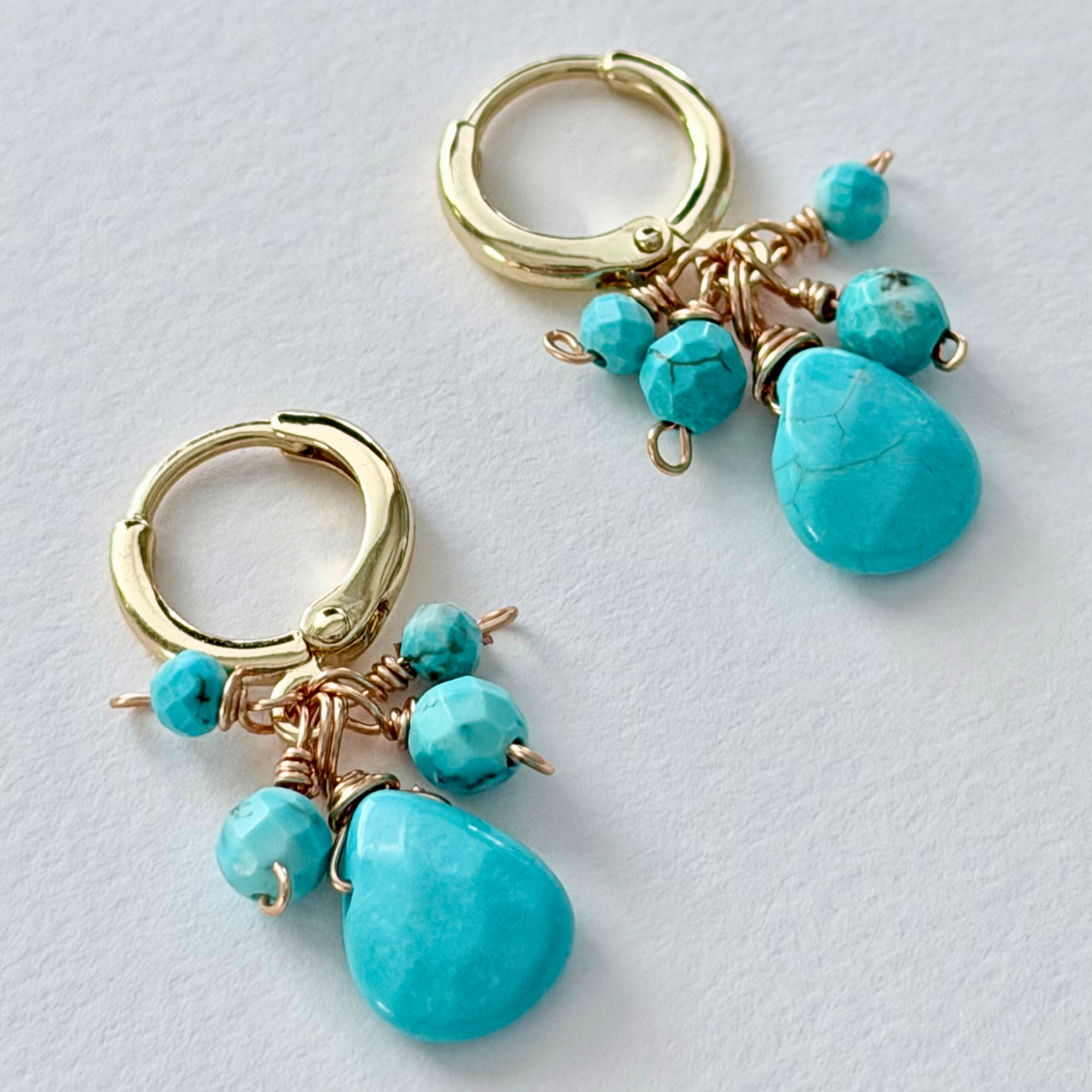 14k gold filled hoop earrings with turquoise beads on a light gray background