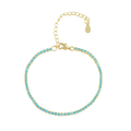 Gold bracelet with turquoise stones on a white background