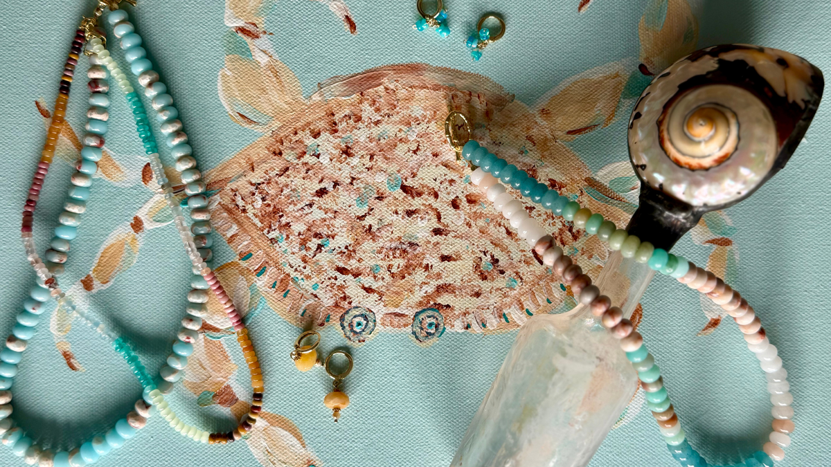 Coastal handmade jewelry with turquoise, pearls and colorful gemstones styled over original fish artwork by Marie & Oakley